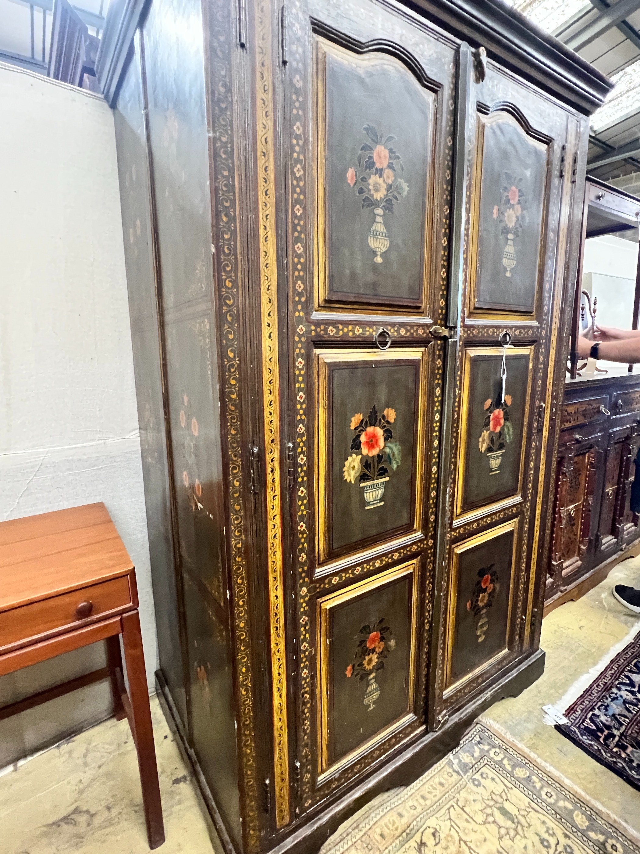 An Indian painted hardwood two door cupboard, width 120cm, depth 70cm, height 185cm